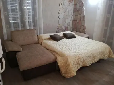 a bedroom with a bed and a chair at STONE HOUSE e Casa Vacanze Zia Rosina in Montemaggiore Belsito