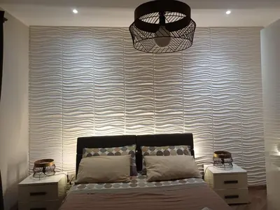 a bedroom with a bed and a large wall at Terra Sinus Holiday House in Terrasini