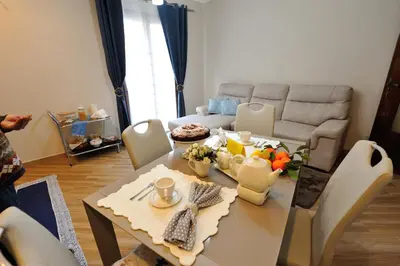 a living room with a table and a couch at Terra Sinus Holiday House in Terrasini