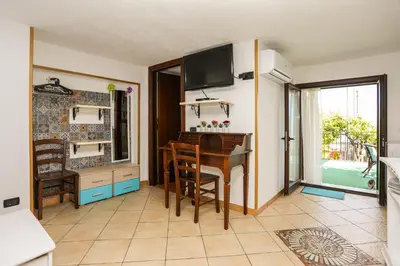 a dining room with a table and a television at Benvenuti al Sud in Trabia