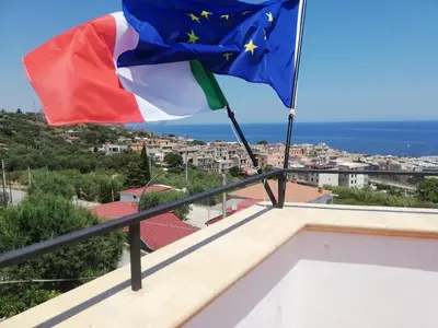 a flag and a european flag on top of a house at Benvenuti al Sud in Trabia