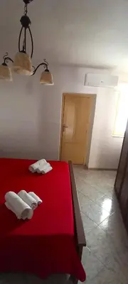 two towels on a red bed in a room at casa nina in Mondello