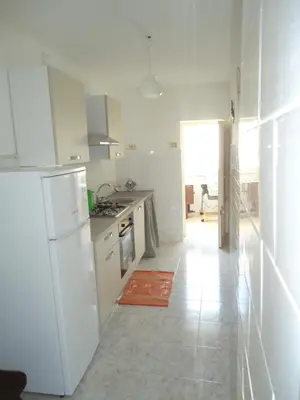 a kitchen with a white refrigerator and a stove at casa nina in Mondello