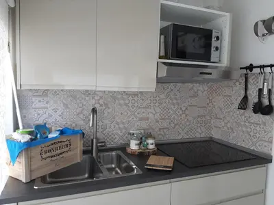 a kitchen with a sink and a box on the counter at Finestra Azzurra in San Vito lo Capo