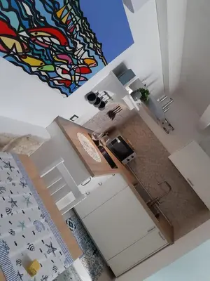 an overhead view of a room with a kitchen with a sink at Finestra Azzurra in San Vito lo Capo