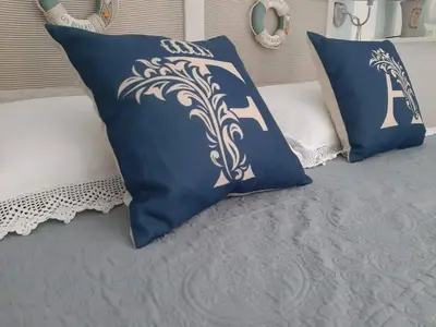 two blue and white pillows on a bed at Finestra Azzurra in San Vito lo Capo