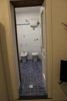a bathroom with a toilet and a sink at cocciu d'amuri in Caccamo