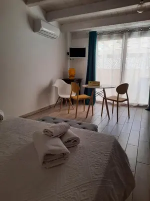 a bedroom with a bed and a table and chairs at Casa di Magda in Castellammare del Golfo