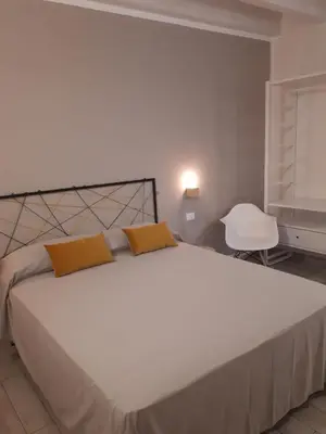 a bedroom with a large white bed with two yellow pillows at Casa di Magda in Castellammare del Golfo