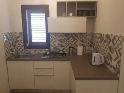 a small kitchen with a sink and a window at Casa di Magda in Castellammare del Golfo