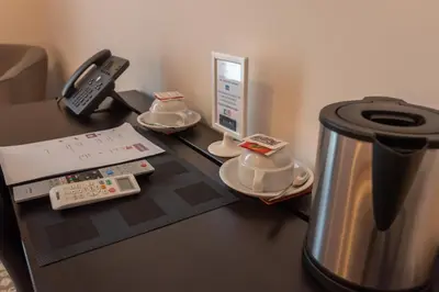 a table with a coffee maker and a phone on it at Liberty Palace in Palermo