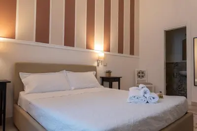 a bedroom with a bed with two towels on it at Liberty Palace in Palermo