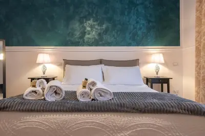 a bedroom with a bed with towels on it at Liberty Palace in Palermo