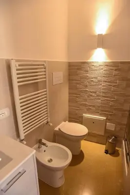 a bathroom with a toilet and a sink at Rooms 19 B&B in Palermo