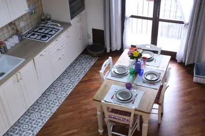 a kitchen with a table with plates and flowers on it at Casa PAN (Percorso Arabo Normanno) in Palermo