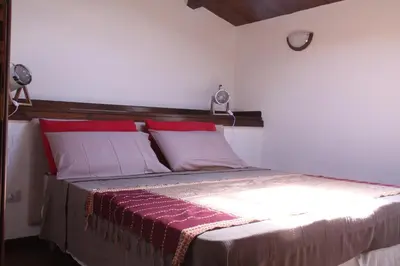 a bedroom with a bed with red and white pillows at Casa PAN (Percorso Arabo Normanno) in Palermo