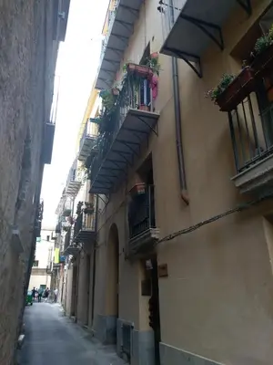 an alley with balconies on the side of a building at Casa PAN (Percorso Arabo Normanno) in Palermo