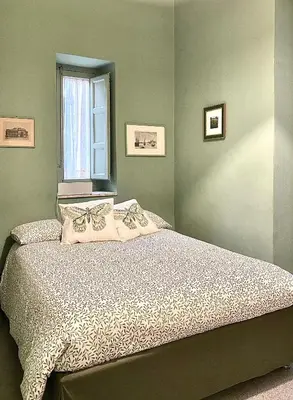 a bedroom with a large bed with a window at Da Nelly al Politeama in Palermo