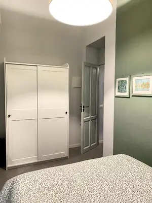 a bedroom with a white closet and a large light at Da Nelly al Politeama in Palermo