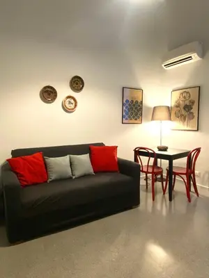 a living room with a black couch and a table at Da Nelly al Politeama in Palermo