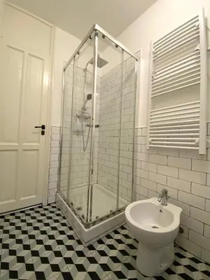 a bathroom with a shower and a toilet and a sink at Da Nelly al Politeama in Palermo
