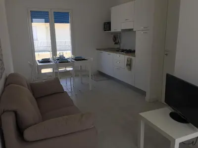 a living room with a couch and a kitchen at Alcamo Marina Residence in Alcamo Marina