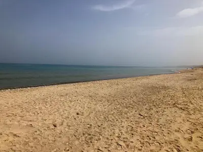 a sandy beach with the ocean in the background at Alcamo Marina Residence in Alcamo Marina