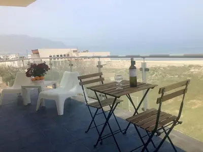 a patio with a table and chairs and a bottle of wine at Alcamo Marina Residence in Alcamo Marina
