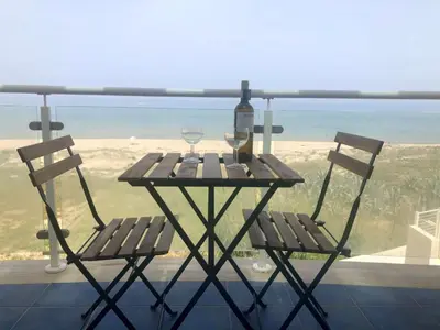 a picnic table with two chairs and a wine glass at Alcamo Marina Residence in Alcamo Marina