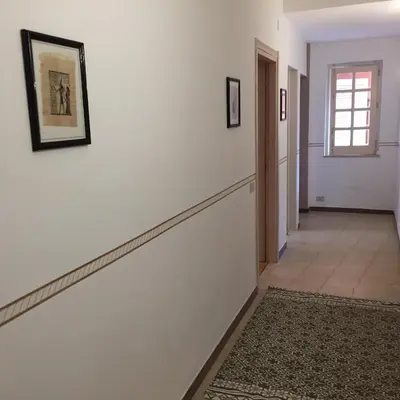 a hallway with white walls and a stair case at George House Mondello 34 in Mondello