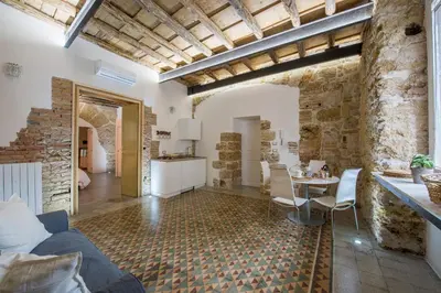 a living room with a couch and a table at Stylish Home in Front of Casa Professa by Wonderful Italy in Palermo