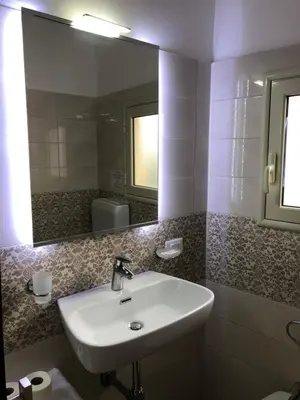 a bathroom with a sink and a mirror at Apartment Rua Formaggi in Palermo