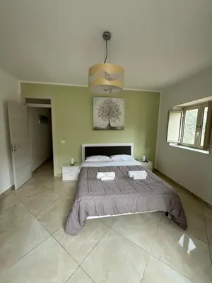 a bedroom with a large bed and a chandelier at Apartment Rua Formaggi in Palermo