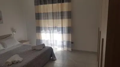 a bedroom with a bed with two towels on it at Giusy's Place 1 in Campofelice di Roccella