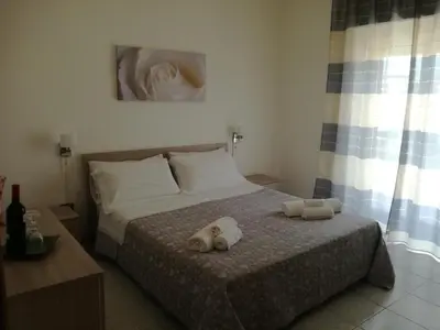 a bedroom with a bed with two towels on it at Giusy's Place 1 in Campofelice di Roccella