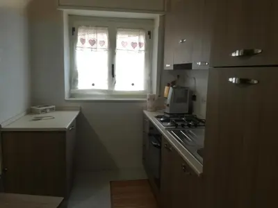 a small kitchen with a stove and a window at Giusy's Place 1 in Campofelice di Roccella
