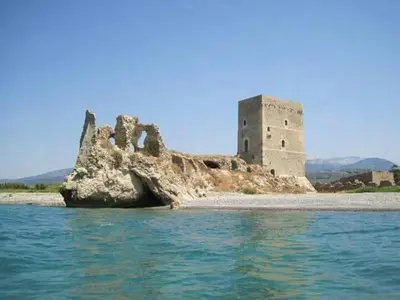 a castle on an island in the water at Giusy's Place 1 in Campofelice di Roccella
