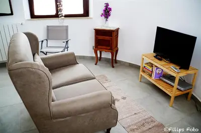a living room with a couch and a tv at Villa Lindi in Castellammare del Golfo
