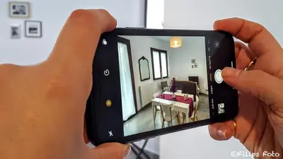 a person taking a picture of a dining room at Villa Lindi in Castellammare del Golfo