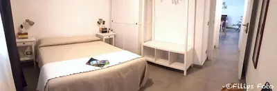 a small room with two beds and a mirror at Villa Lindi in Castellammare del Golfo
