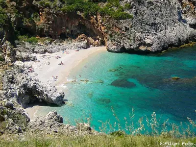 a group of people on a beach in the water at Villa Lindi in Castellammare del Golfo