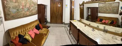 a living room with two couches and a mirror at Arco di ballarò in Palermo