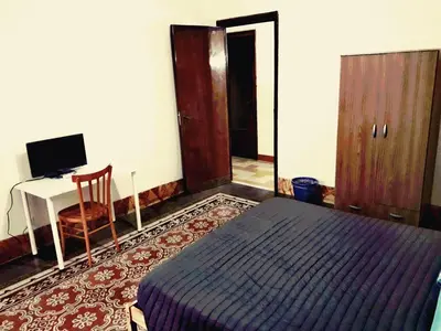 a bedroom with a bed and a desk with a computer at Arco di ballarò in Palermo
