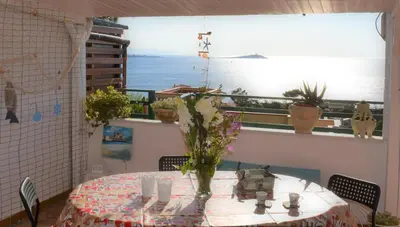 a table with a vase of flowers on it at tramonto blu in Palermo