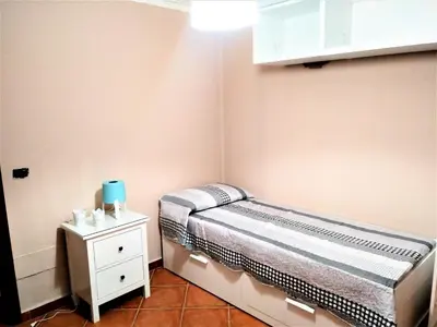 a small bedroom with a bed and a nightstand at tramonto blu in Palermo