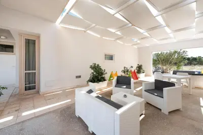 a living room with white furniture and a white ceiling at Vitorno Residence in San Vito lo Capo
