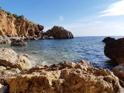 a group of rocks in the water near the ocean at 'A Cumerdia - Casa Vacanze in Castellammare del Golfo