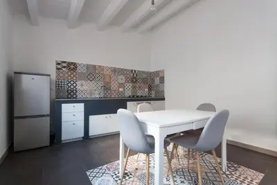 a kitchen with a white table and chairs at Casa Leonardo e Romeo in Castellammare del Golfo