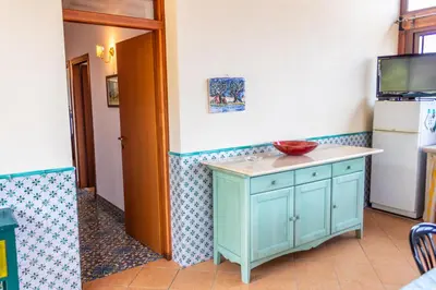 a kitchen with a blue cabinet with a bowl on it at Villa Verde con vista sul mare in San Vito lo Capo