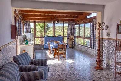a living room with a table and chairs at Villa Azzurra con vista sul mare in San Vito lo Capo